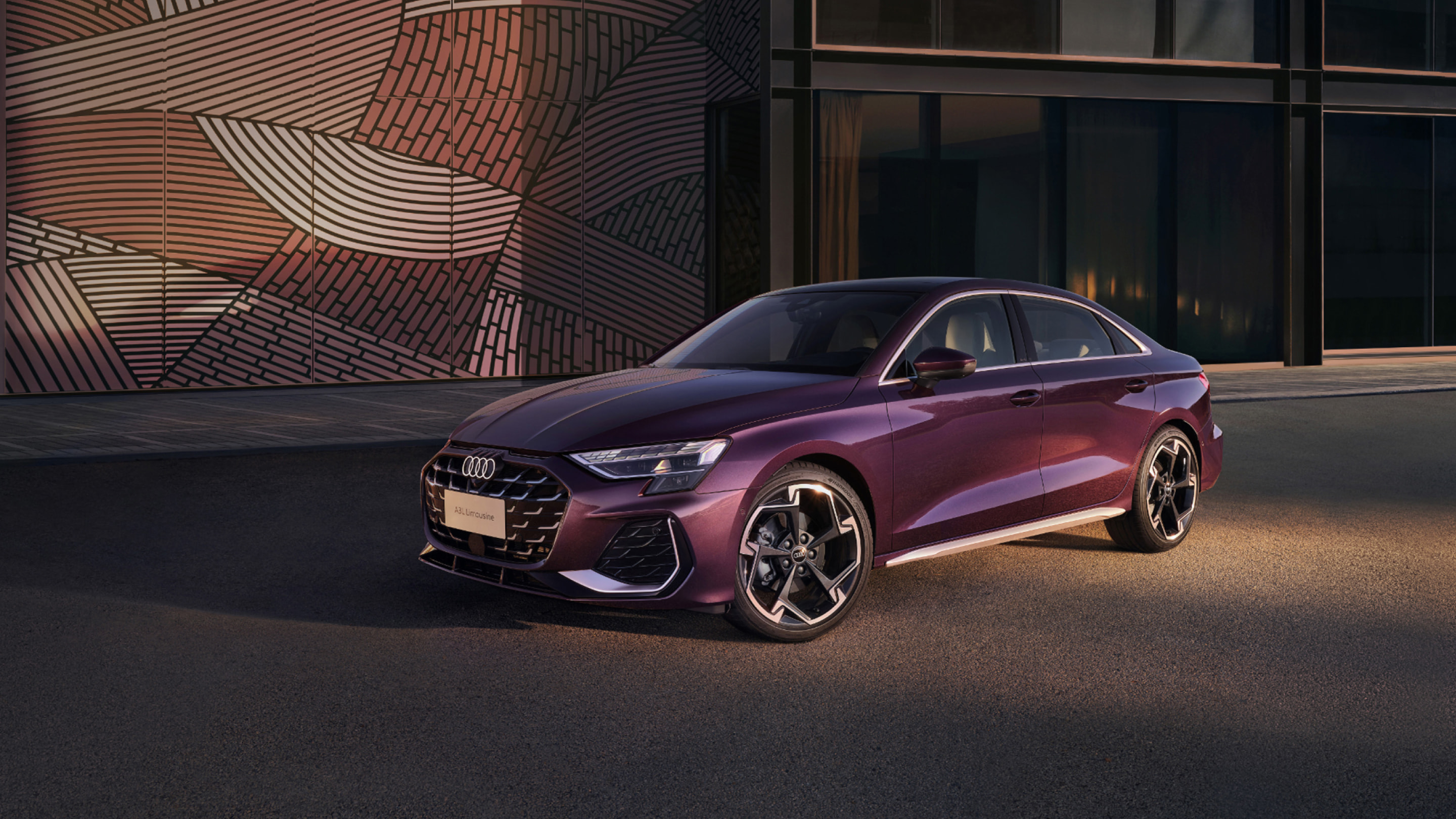Purple Audi A3L Limousine beside an architectural wall; official Audi China image, candidate condition not implied